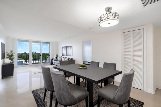a bedroom with a large bed and a potted plant