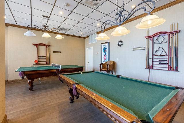 a reading room with furniture and a potted plant
