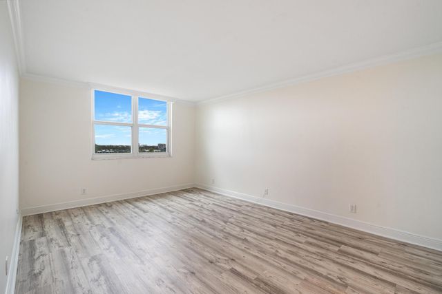 a view of an empty room and wooden floor