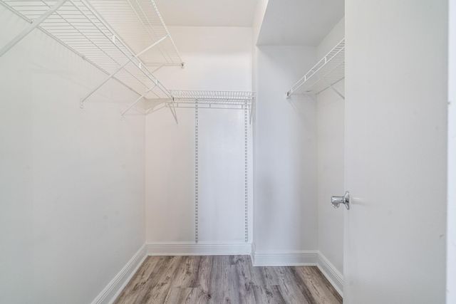 a bathroom with a granite countertop bathtub shower sink vanity mirror and toilet