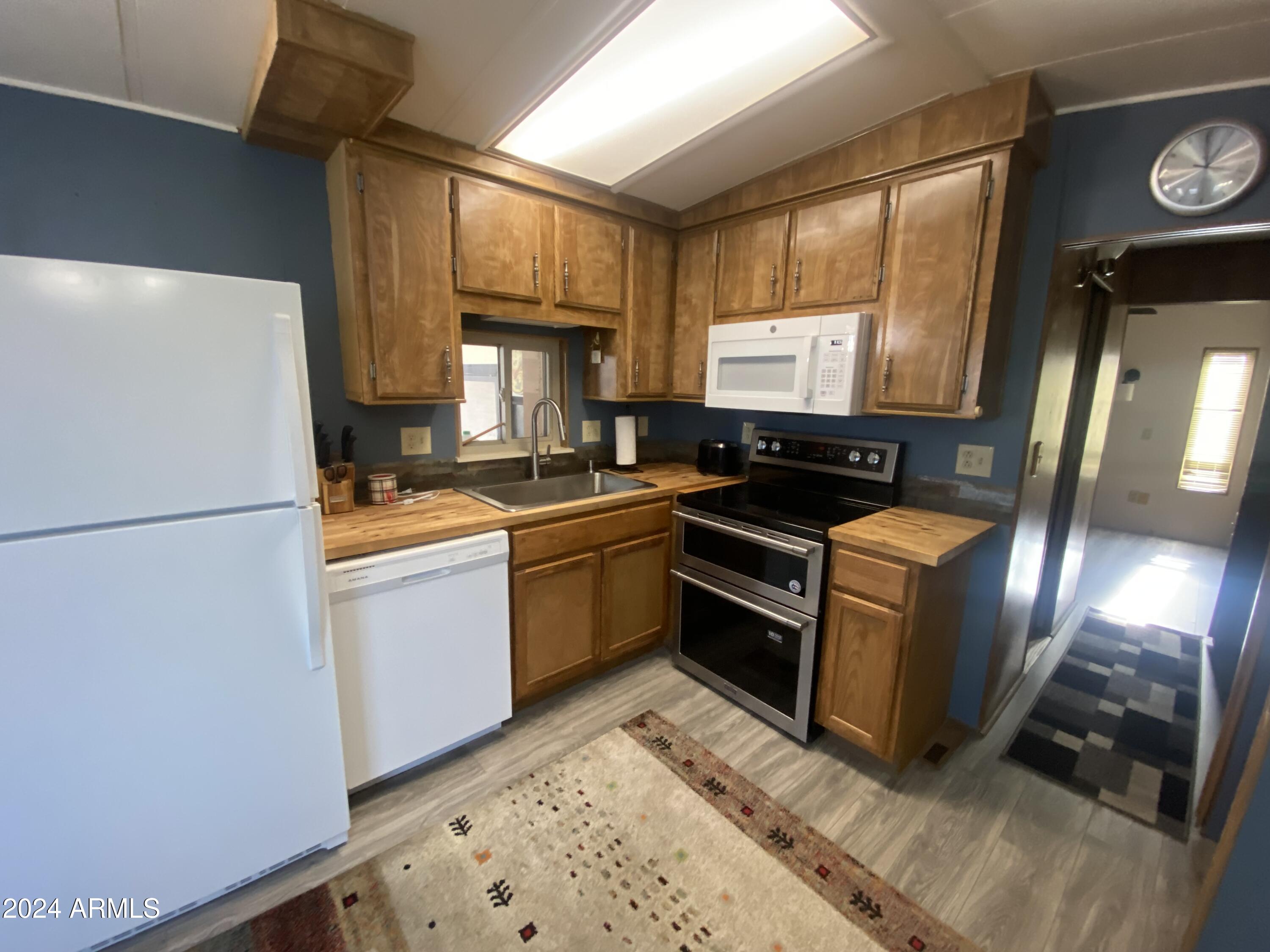 2323 South Pomo Avenue Apache Junction, AZ 85119 - Photo 6 of 42 a kitchen with a refrigerator and a stove