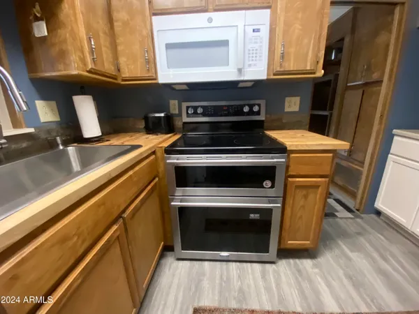 a stove top oven sitting inside of a kitchen