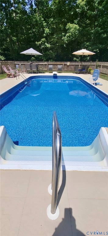 5010 Tatum Road Disputanta, VA 23842 - Photo 4 of 5 Fenced swimming pool with integrated steps, surrou