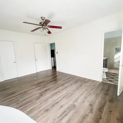 a view of a room with wooden floor