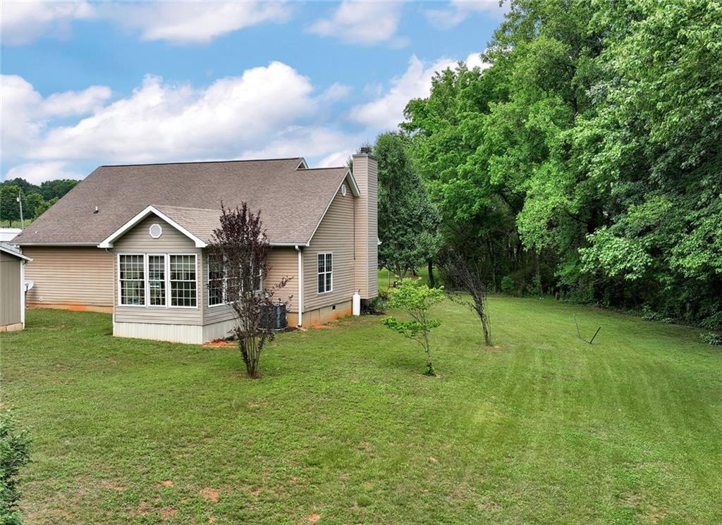 1044 Lothridge Road Cleveland, GA 30528 - Photo 33 of 40 a front view of a house with a yard and trees
