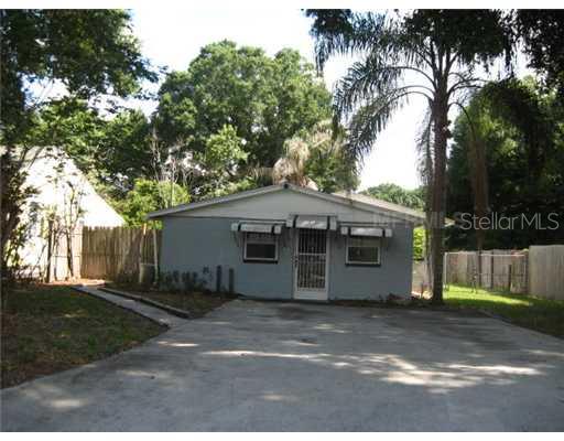 1212 West Marjorie Street Lakeland, FL 33815 - Photo 1 of 1 a view of a house with a yard plants and large trees