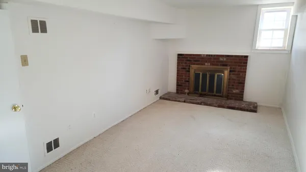 a view of empty room with a fireplace