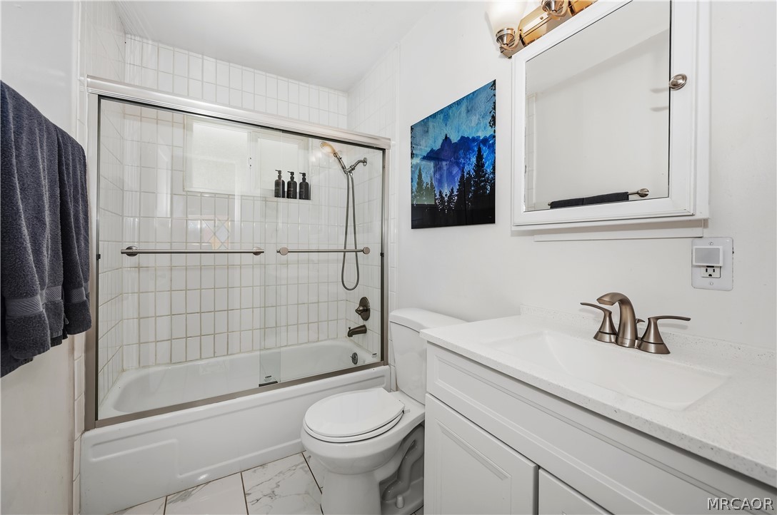 1099 Canyon Road Fawnskin, CA 92333 - Photo 21 of 39 a bathroom with a sink a toilet and shower