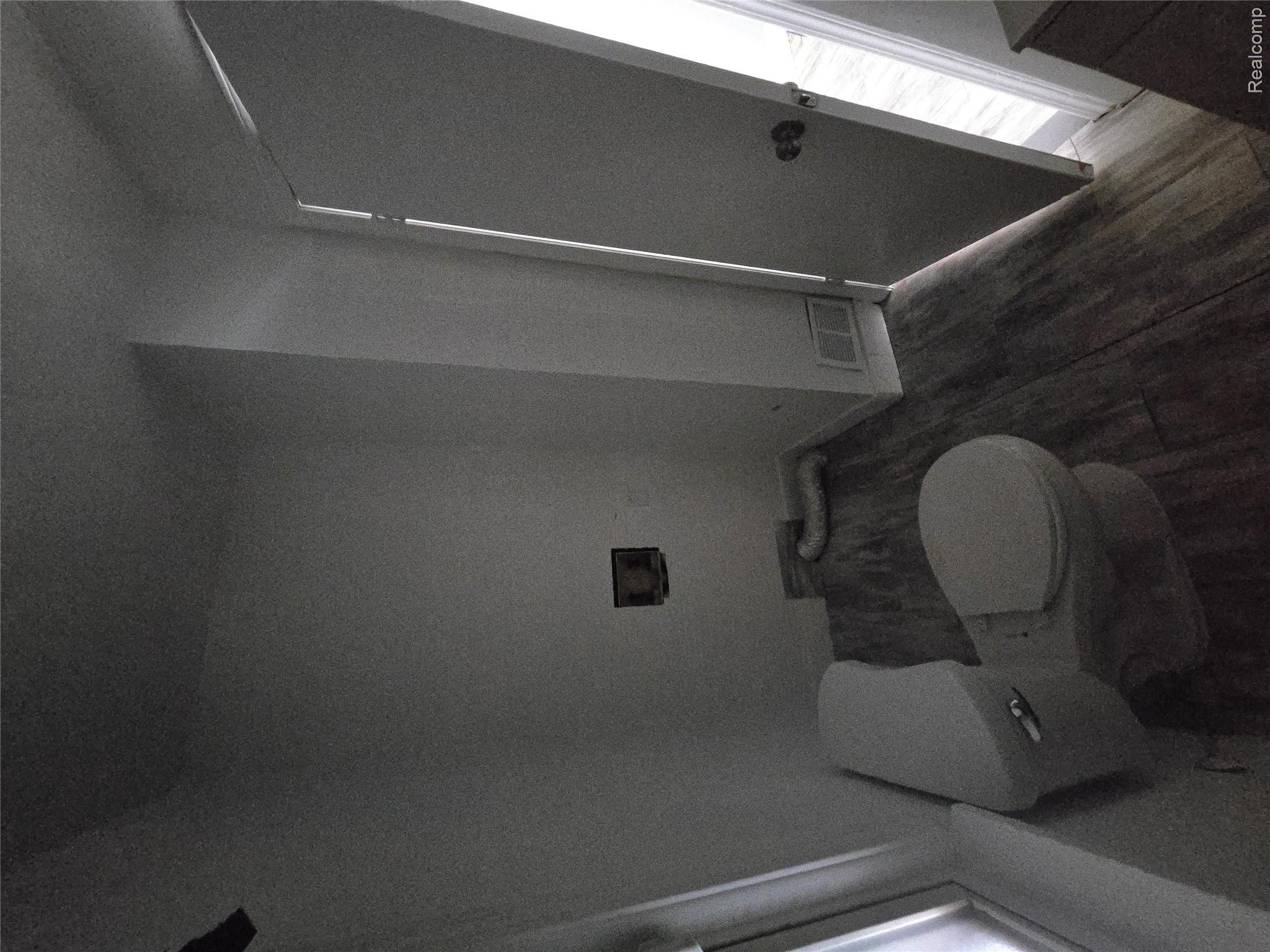 18119 Cornwall Street Detroit, MI 48224 - Photo 9 of 18 Bathroom featuring toilet and dark wood-style floors
