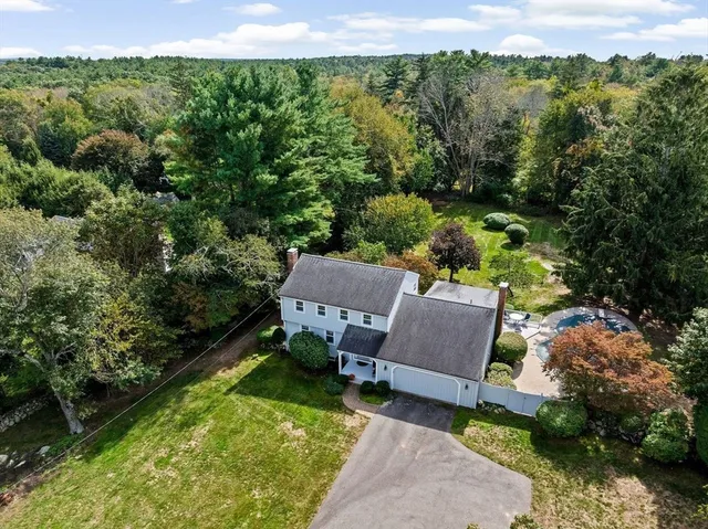 an aerial view of a house with pool outdoor seating and yard