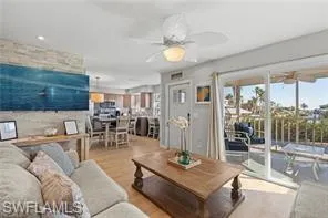 a living room with furniture a table and kitchen view