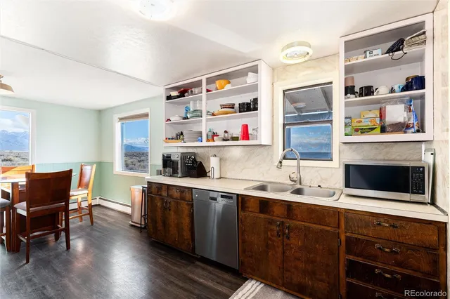 a kitchen with stainless steel appliances a stove a sink and a refrigerator