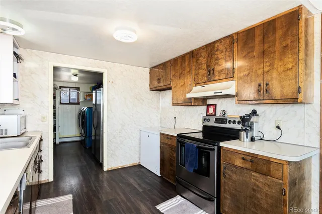 a kitchen with stainless steel appliances a cabinets and wooden floor