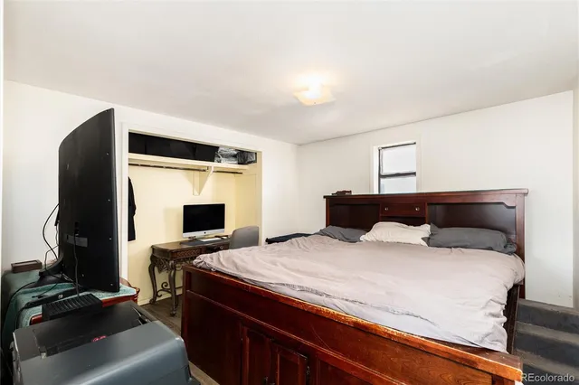 a bathroom with a granite countertop sink mirror vanity and toilet