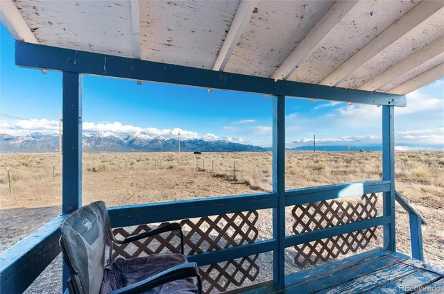 a view of roof deck with wooden floor and outdoor seating