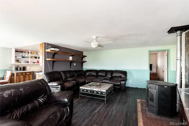 a living room with furniture a ceiling fan and a rug