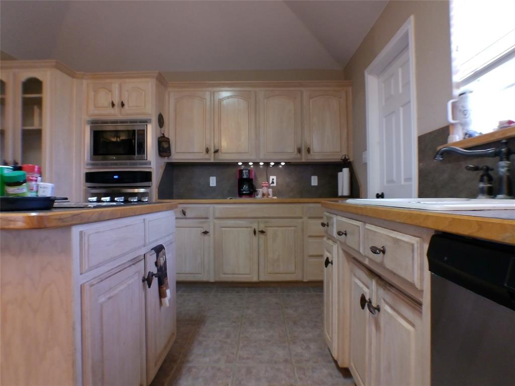 200 County Road 3170 Decatur, TX 76234 - Photo 18 of 31 a kitchen with cabinets stainless steel appliances and a window