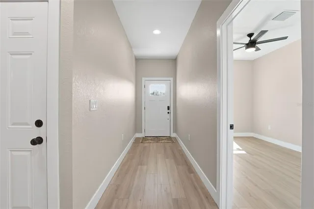 a view of a hallway with wooden floor