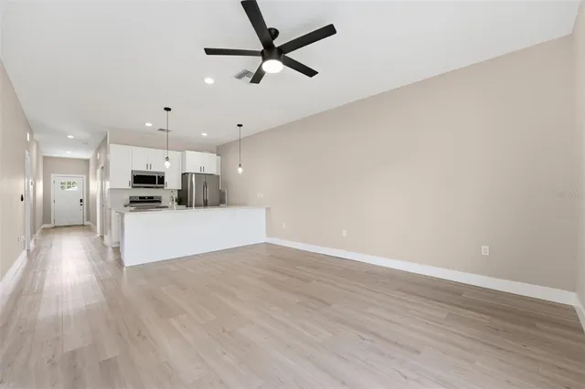 a view of a kitchen with a sink and a refrigerator
