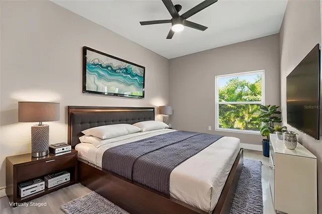 a bedroom with a bed and a flat screen tv