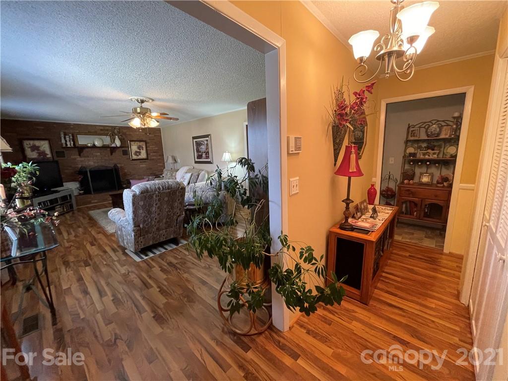 180 Watergate Drive Alexis, NC 28006 - Photo 12 of 40 a living room with fireplace furniture and wooden floor