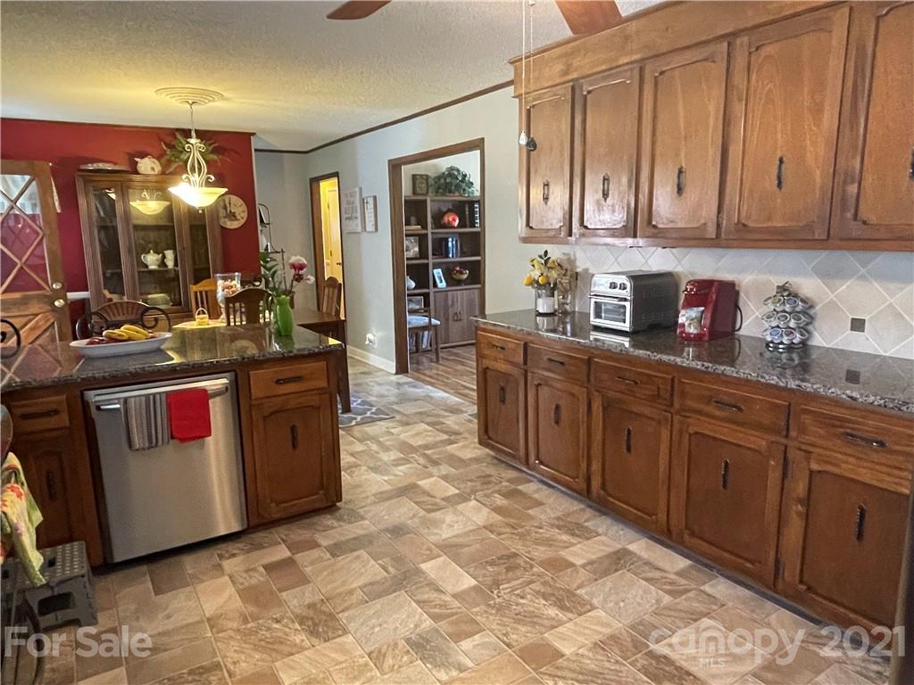 180 Watergate Drive Alexis, NC 28006 - Photo 22 of 40 a kitchen with stainless steel appliances granite countertop a stove sink and cabinets
