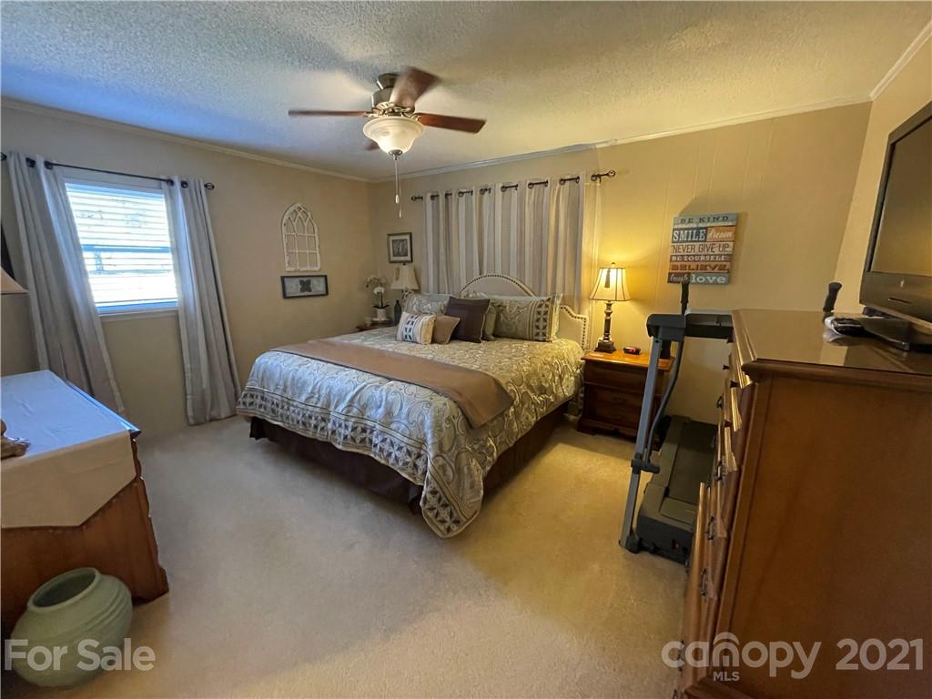 180 Watergate Drive Alexis, NC 28006 - Photo 27 of 40 a bedroom with a bed flat screen tv and window