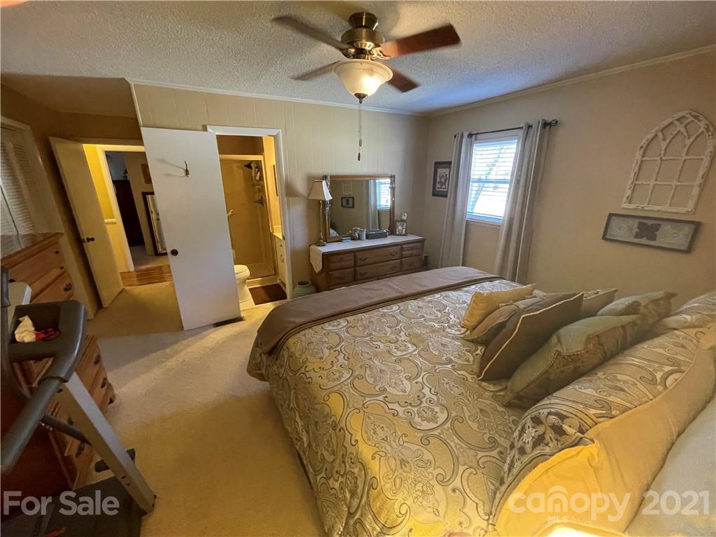 180 Watergate Drive Alexis, NC 28006 - Photo 28 of 40 a bedroom with a bed a flat tv screen and dresser