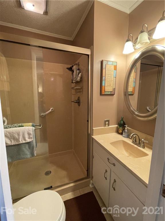 180 Watergate Drive Alexis, NC 28006 - Photo 29 of 40 a bathroom with a granite countertop sink toilet and shower