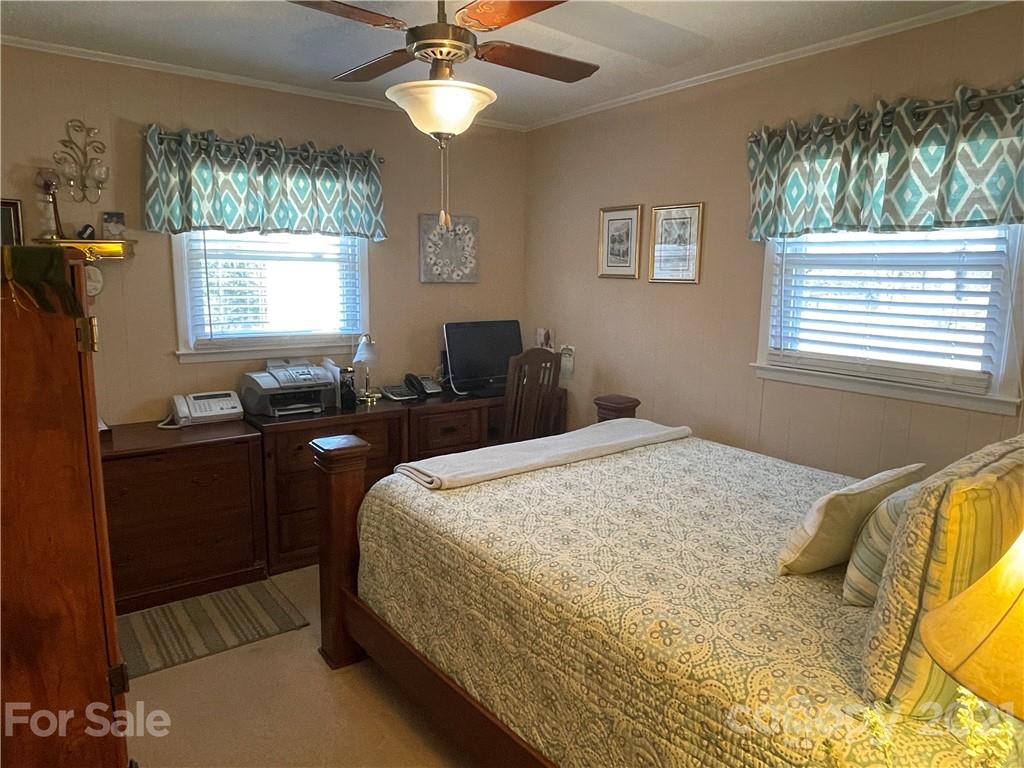 180 Watergate Drive Alexis, NC 28006 - Photo 30 of 40 a bedroom with a bed and a chandelier