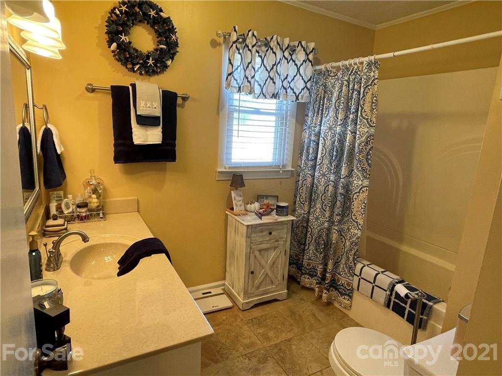 180 Watergate Drive Alexis, NC 28006 - Photo 33 of 40 a bathroom with a sink toilet and shower