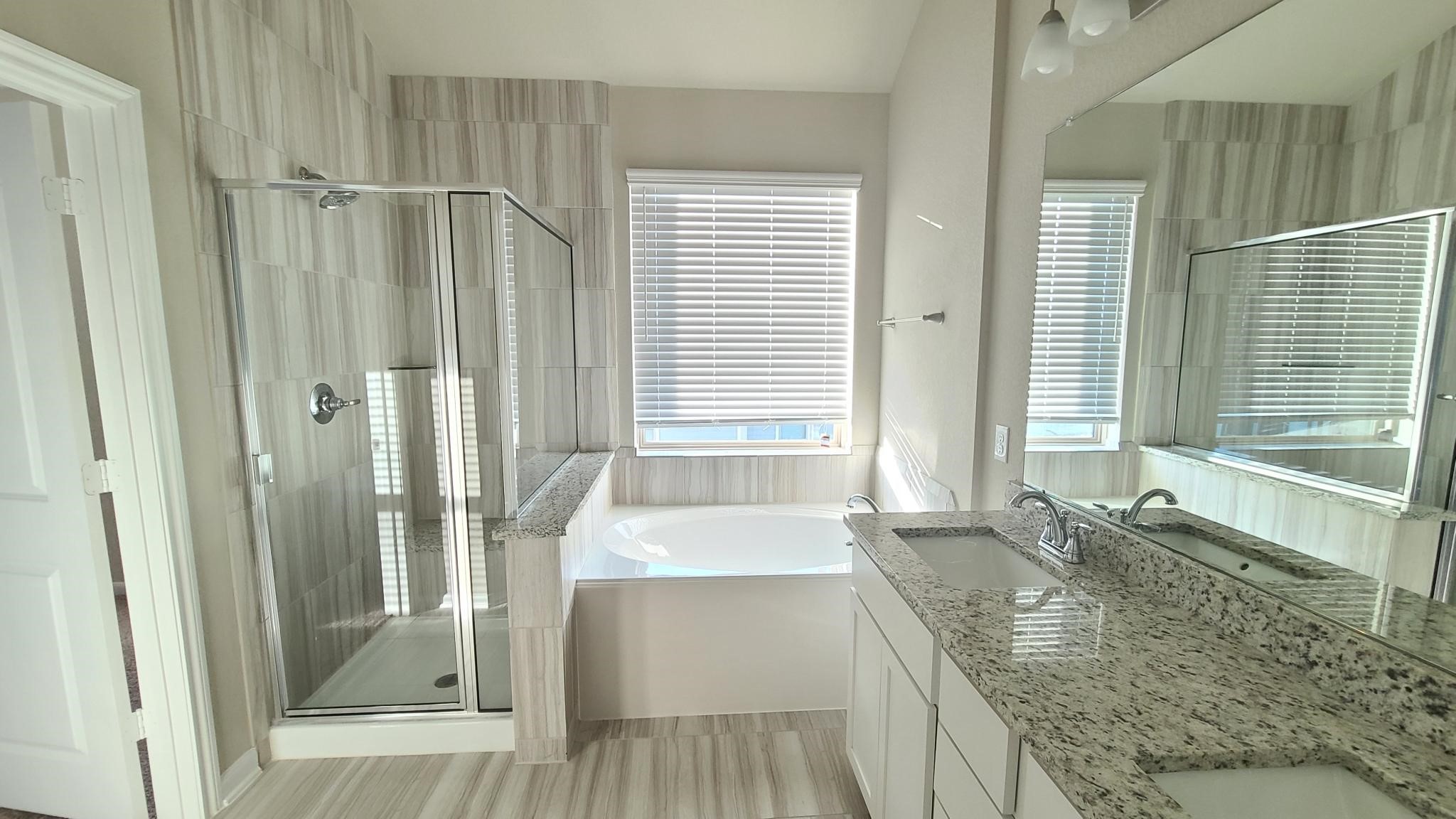 4241 Merry Mill Drive Spring, TX 77386 - Photo 13 of 24 a bathroom with shower a bathtub and a sink