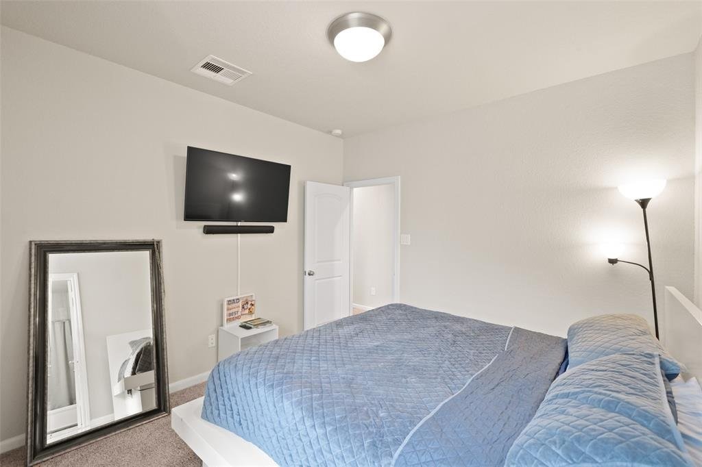 4241 Merry Mill Drive Spring, TX 77386 - Photo 16 of 24 a bedroom with a bed and a flat screen tv