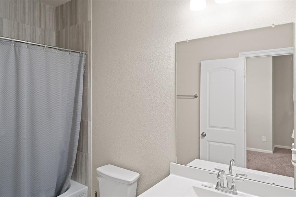 4241 Merry Mill Drive Spring, TX 77386 - Photo 20 of 24 a bathroom with a sink and a toilet