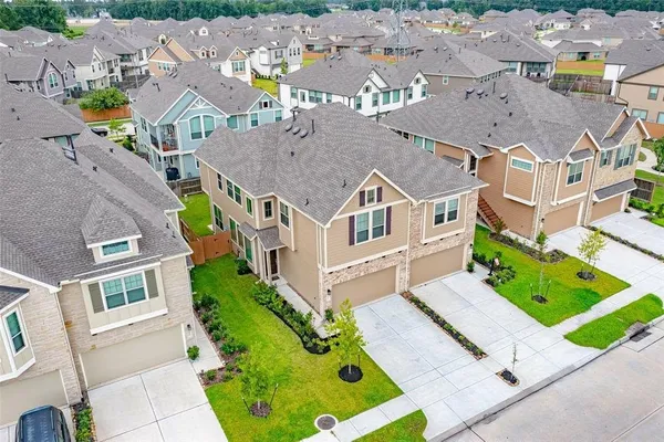 an aerial view of residential houses with outdoor space
