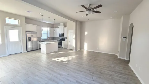 a view of a kitchen with a sink a refrigerator and cabinets