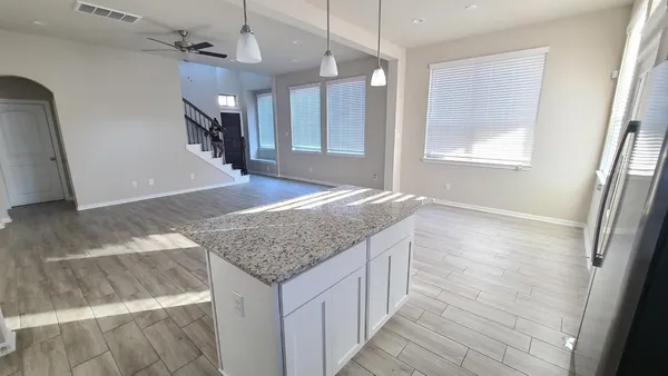 a bathroom with a granite countertop sink a toilet and a bathtub