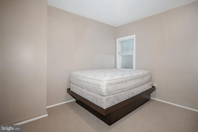 a room with a bed and window