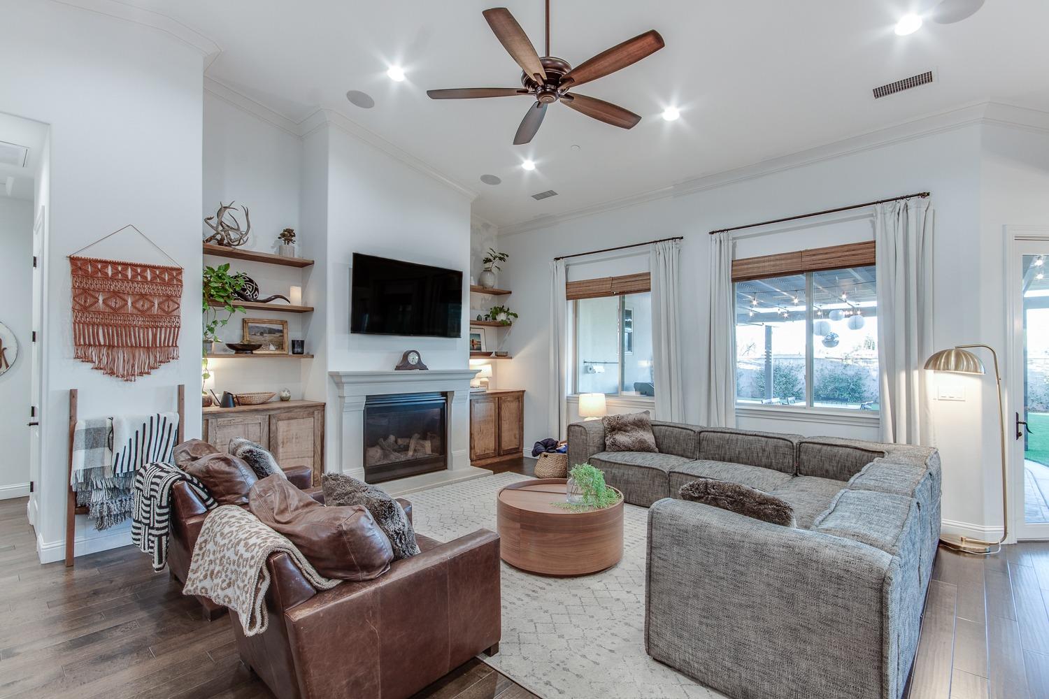 1437 Jordan Avenue Clovis, CA 93611 - Photo 11 of 53 a living room with furniture a fireplace and a flat screen tv