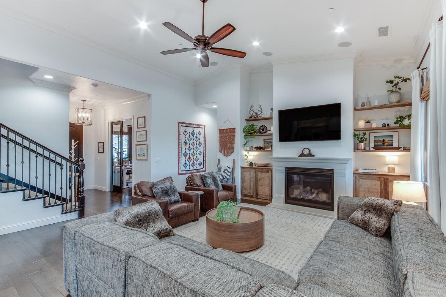 1437 Jordan Avenue Clovis, CA 93611 - Photo 12 of 53 a living room with furniture a flat screen tv and a fireplace