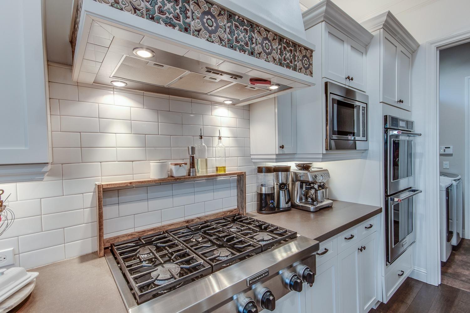 1437 Jordan Avenue Clovis, CA 93611 - Photo 16 of 53 a kitchen with stainless steel appliances granite countertop a stove and a refrigerator