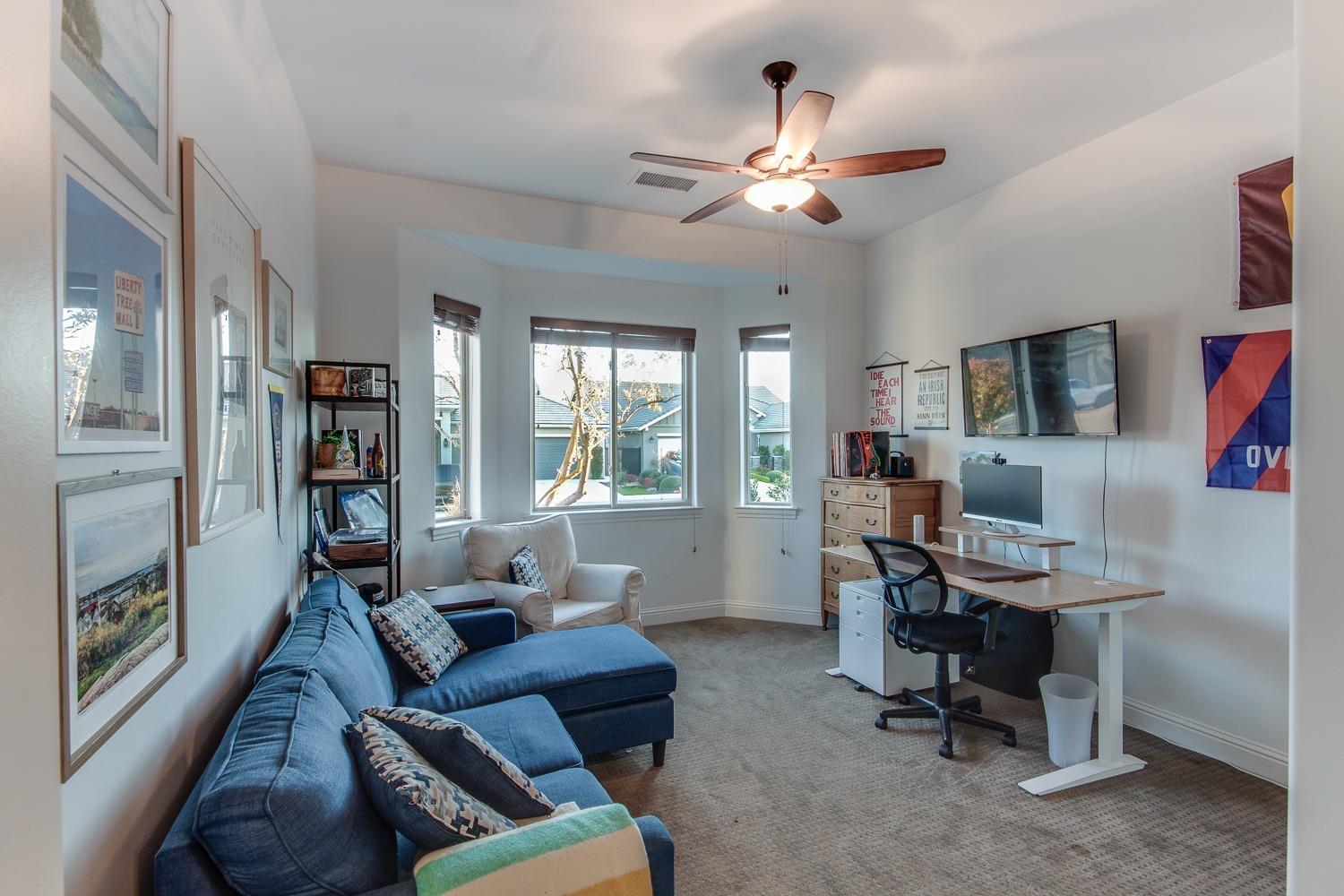 1437 Jordan Avenue Clovis, CA 93611 - Photo 21 of 53 a living room with furniture and a chandelier