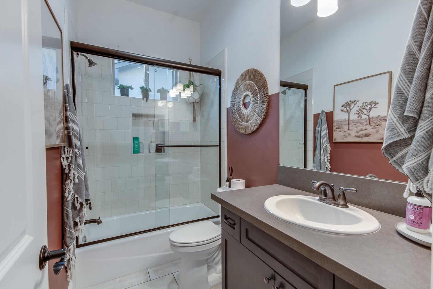 1437 Jordan Avenue Clovis, CA 93611 - Photo 23 of 53 a bathroom with a sink a toilet and a mirror