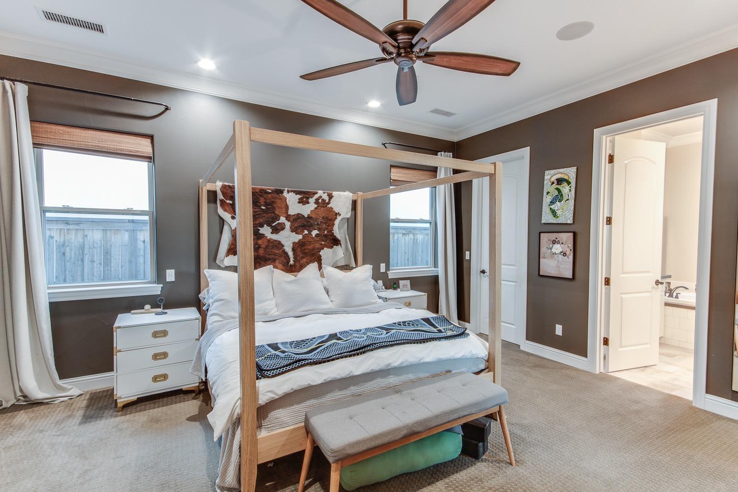 1437 Jordan Avenue Clovis, CA 93611 - Photo 24 of 53 a bedroom with a large bed and a chandelier