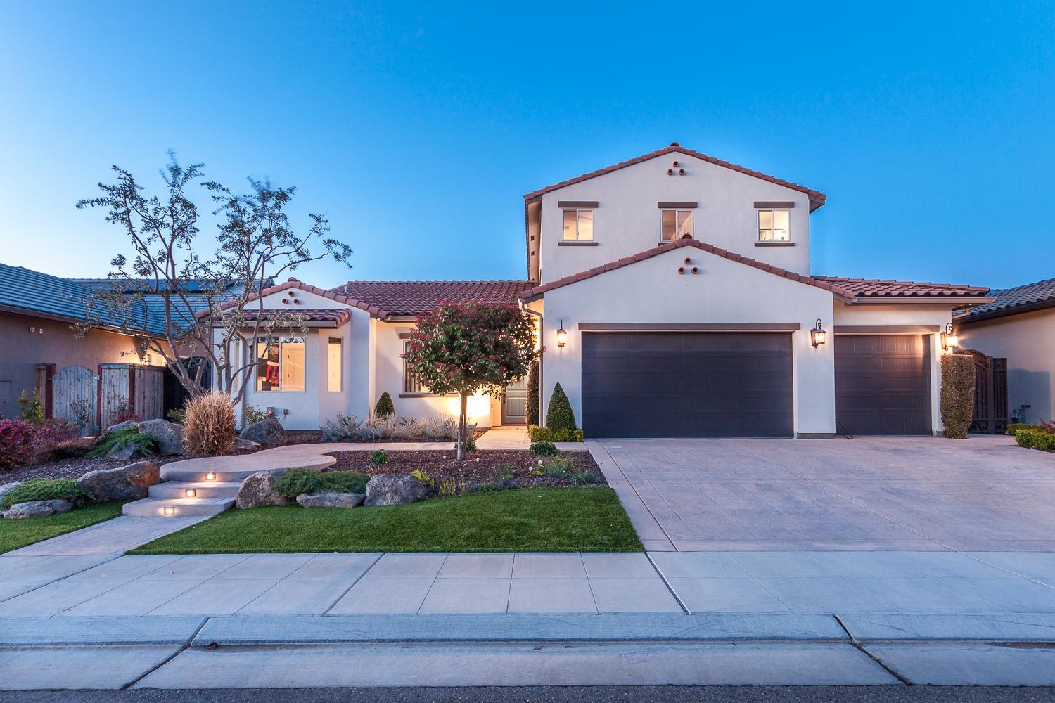 1437 Jordan Avenue Clovis, CA 93611 - Photo 3 of 53 a front view of a house with a yard and garage