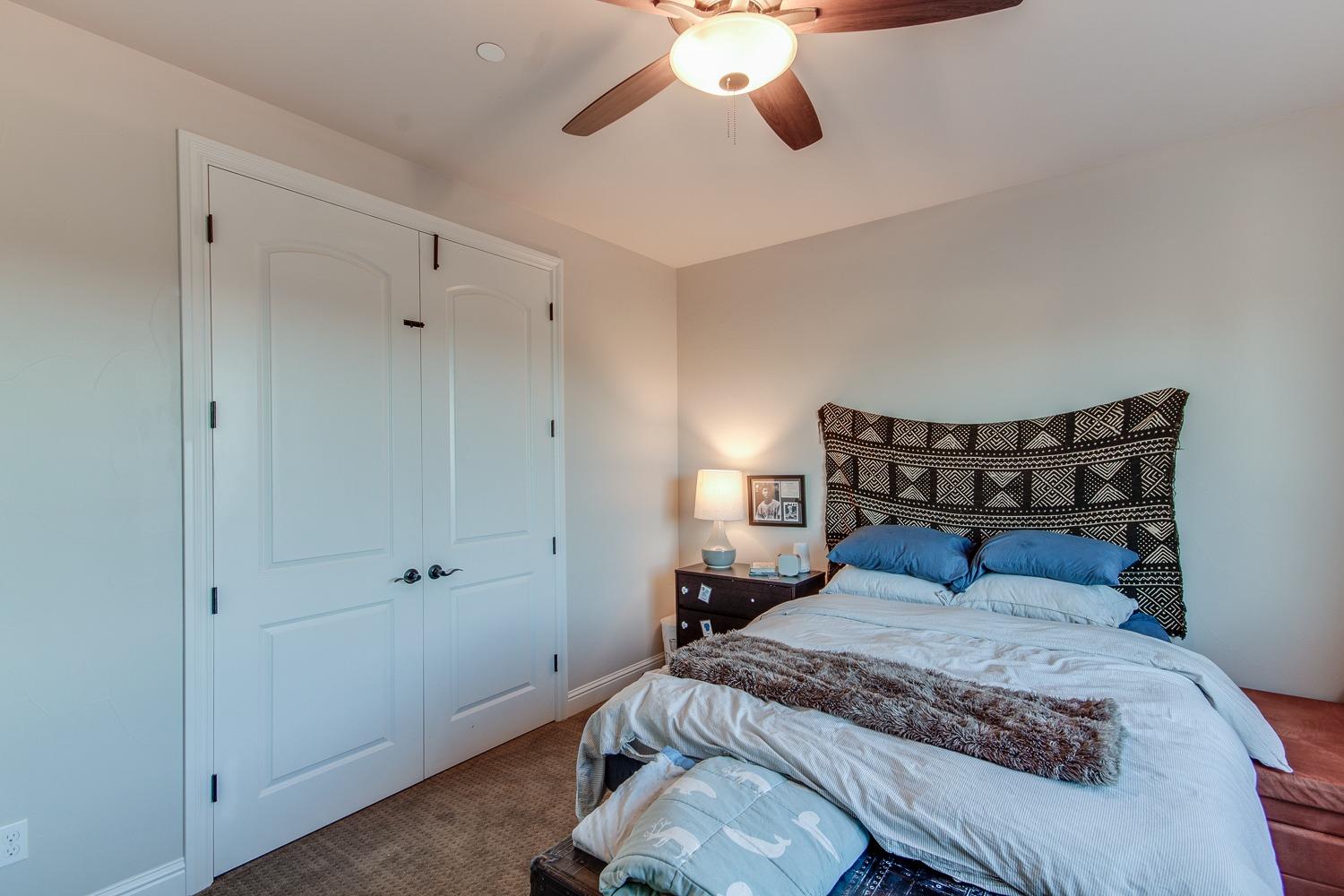 1437 Jordan Avenue Clovis, CA 93611 - Photo 31 of 53 a bedroom with a bed and ceiling fan