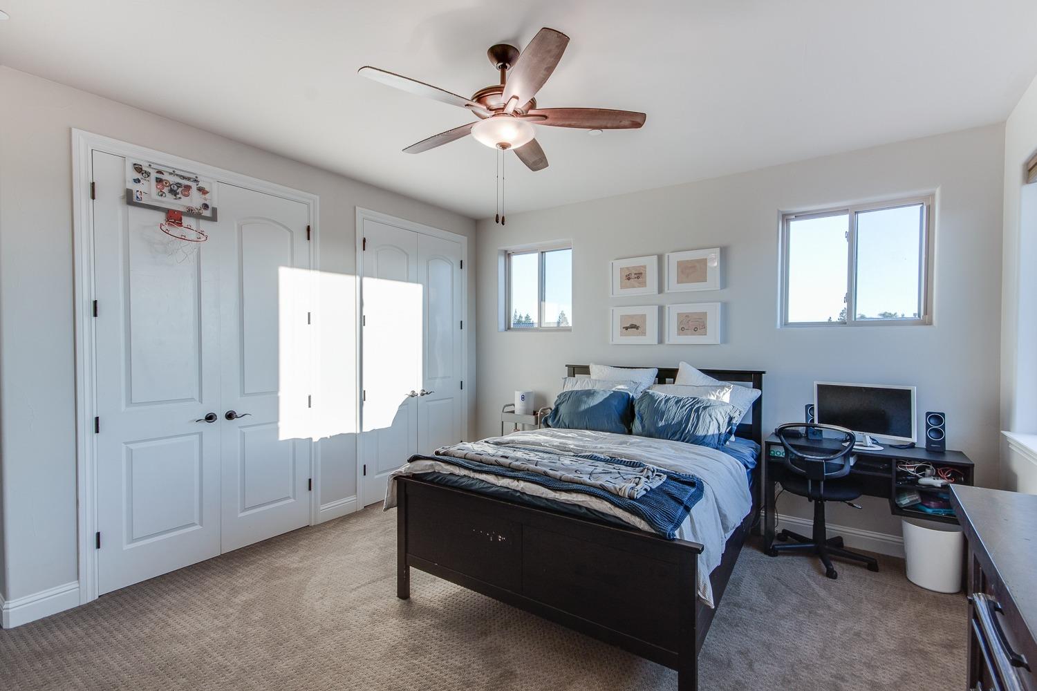 1437 Jordan Avenue Clovis, CA 93611 - Photo 36 of 53 a bedroom with a bed and a chandelier