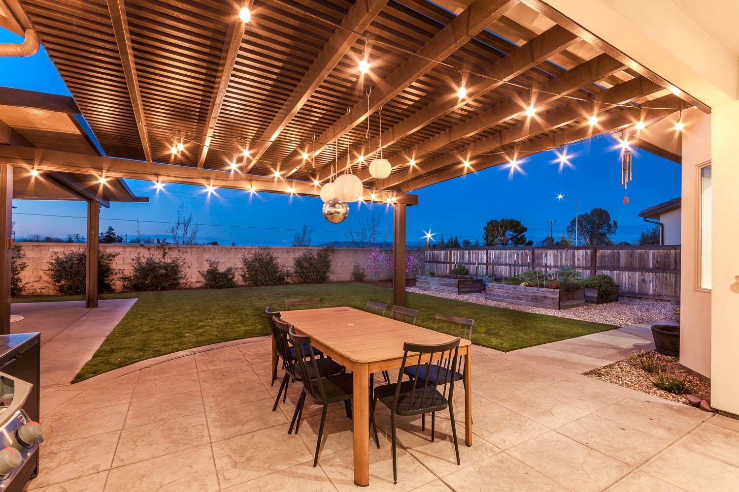 1437 Jordan Avenue Clovis, CA 93611 - Photo 38 of 53 a view of a backyard with table and chairs a barbeque with potted plants