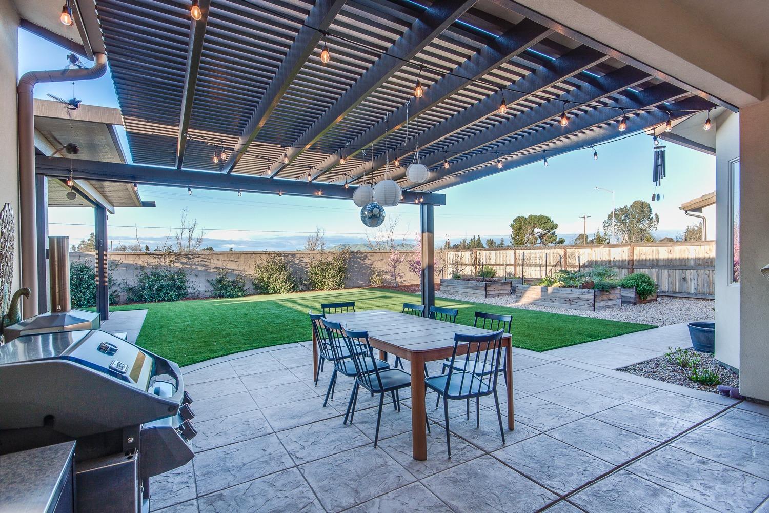 1437 Jordan Avenue Clovis, CA 93611 - Photo 43 of 53 a view of a patio with a table chairs and a backyard