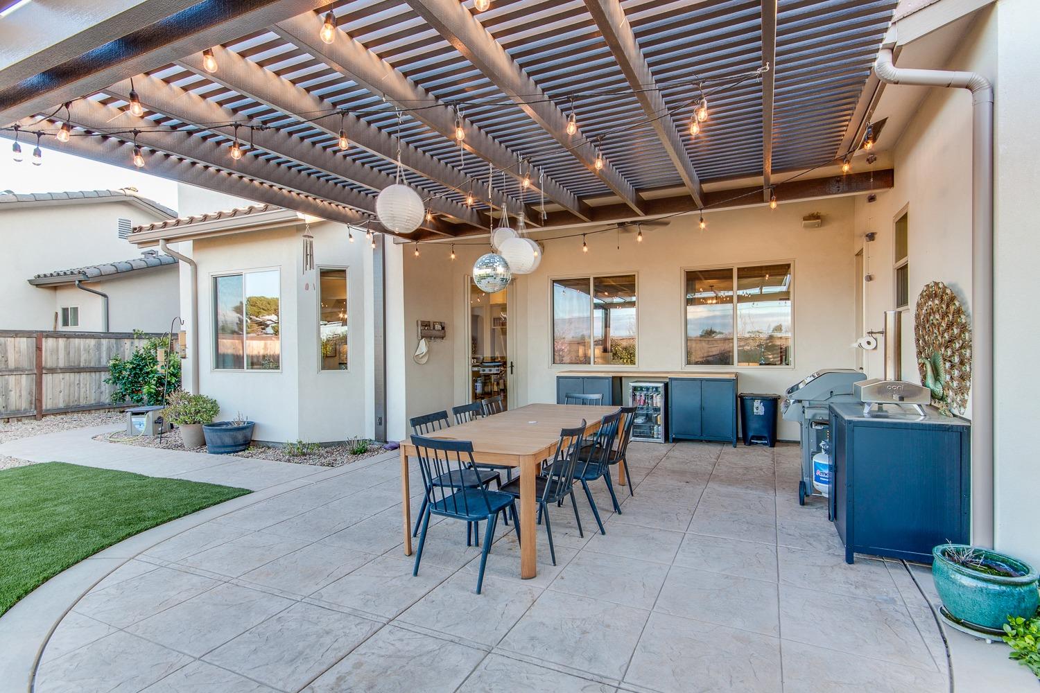 1437 Jordan Avenue Clovis, CA 93611 - Photo 46 of 53 a view of a porch with dining table and chairs with wooden floor